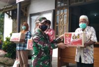 Dandim 1013/Mtw Rinaldi Irawan menyerahkan paket sembako kepada warga