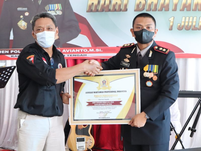 Ade Soebara Noor, Ketua AWPI Barsel (kiri) saat menyerahkan piagam penghargaan kepada AKBP Yusfandi Usman Kapolres Barsel (kanan). Foto. Alifansyah/1tulah.com