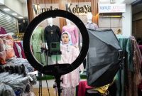 Seorang pedagang melakukan penjualan langsung melalui streaming di sebuah toko di pasar tekstil Tanah Abang di Jakarta, Kamis, 28 September 2023. (AP/Tatan Syuflana)