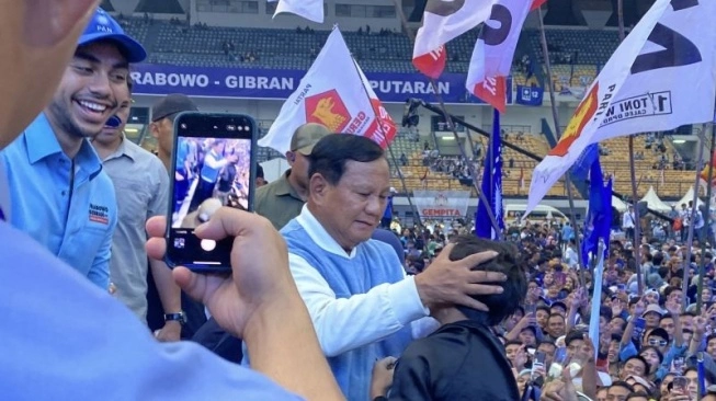 Calon presiden nomor urut 2 Prabowo Subianto mendatangi salah satu anak saat kampanye akbar di Stadion Gelora Bandung Lautan Api, Kota Bandung, Kamis (8/2/2024) (sumber: suara.com)