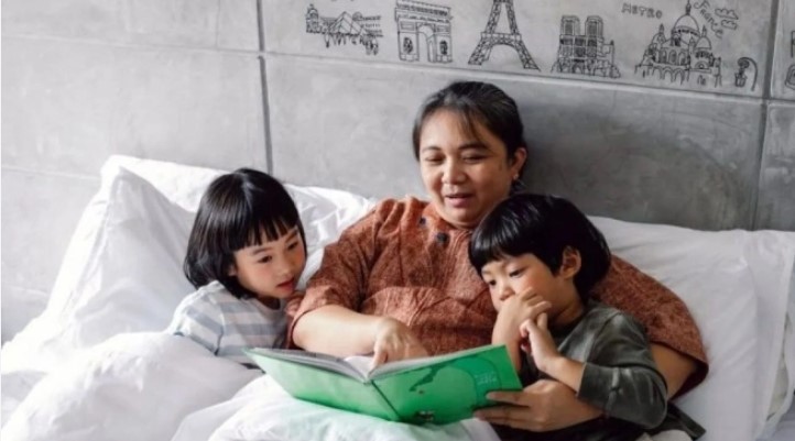 Ilustrasi seorang ibu sedang membacakan buku cerita kepada anak sebelum tidur. [Dok.Antara]