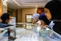 Calon pembeli memilih perhiasan emas di Galeri 24 Pegadaian, Jakarta, Rabu (8/1/2025). [Suara.com/Alfian Winanto]