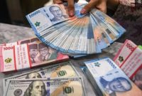 Mata uang rupiah dan dolar Amerika Serikat. [Antara] 