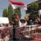 Massa aksi membawa poster dan spanduk saat menggelar aksi damai mendukung keberlanjutan Program Makan Bergizi Gratis (MBG) di Trenggalek, Jawa Timur, Senin (22/6/2026). ANTARA FOTO/Destyan Sujarwoko].